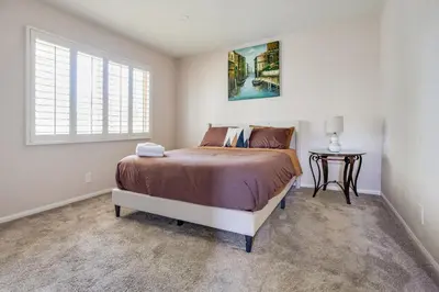 a bedroom with a bed and a table at Cozy 1BR Guest House with Mountain View in Simi Valley in Simi Valley