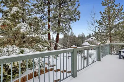 a balcony with a snow covered fence and trees at Modern Relaxation at Castle Glen Gem Big Bear Lake in Big Bear Lake