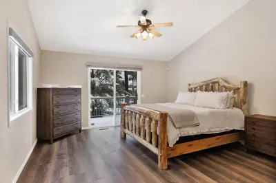 a bedroom with a bed and a ceiling fan at Modern Relaxation at Castle Glen Gem Big Bear Lake in Big Bear Lake