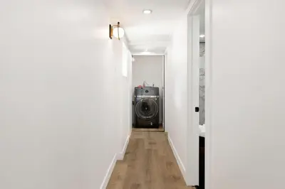 a hallway with a washing machine in a room at Vista Pines at Big Bear Lake– Your Ultimate Mountain Escape in Big Bear Lake