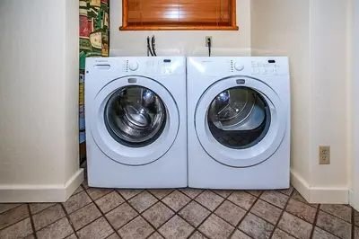 two white washing machines in a room with a tile floor at Pleasant Pause Family Retreat in Big Bear Lake in Fawnskin