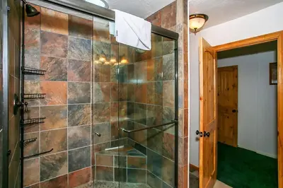 a shower with a glass door in a bathroom at Pleasant Pause Family Retreat in Big Bear Lake in Fawnskin