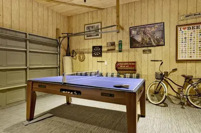 a room with a ping pong table and a bicycle at Pines & Needles Mountain Retreat by Big Bear Vacations in Big Bear Lake