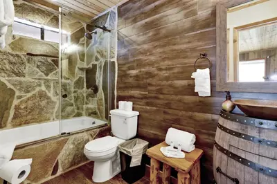 a bathroom with a toilet and a tub and a sink at Pines & Needles Mountain Retreat by Big Bear Vacations in Big Bear Lake