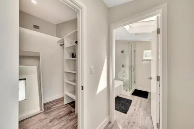 a bathroom with a walk in closet and a mirror at Incredible View, Huge Pool & Basketball! in Tarzana