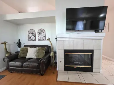 a living room with a couch and a fireplace at Newly Listed Family Friendly Fontana House in Fontana