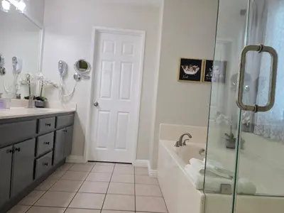 a bathroom with a shower and a sink and a tub at Newly Listed Family Friendly Fontana House in Fontana