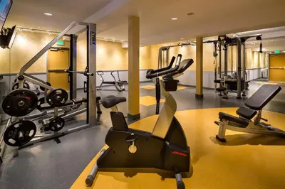a gym with treadmills and elliptical machines at Hotel Aventura in Los Angeles