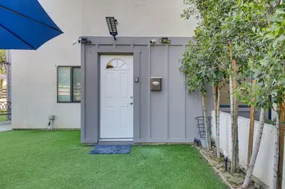 a house with a white door and grass at Luxury guest suite in Los Angeles in North Hills