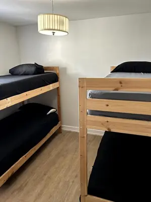 a room with two bunk beds and a lamp at Santa Ana Vibes in Santa Ana