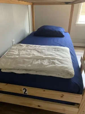 a bed with a blue and white comforter in a room at Santa Ana Vibes in Santa Ana