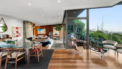 a living room with a glass table and chairs at Waynecrest in Los Angeles