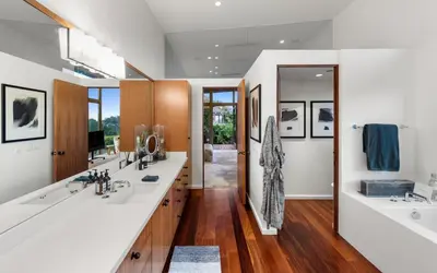 a bathroom with two sinks and two mirrors at Waynecrest in Los Angeles
