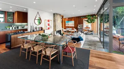 a kitchen and dining room with a glass table and chairs at Waynecrest in Los Angeles
