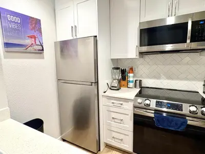 a kitchen with a stainless steel refrigerator and a microwave at Great 2 Bedroom and 2 Bathroom Apartment in Marina in Los Angeles