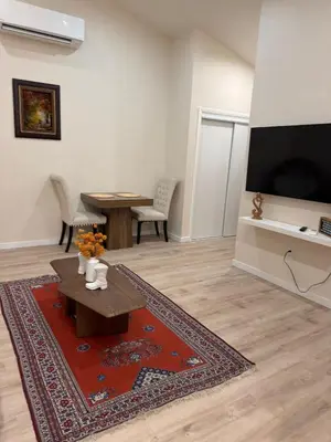 a living room with a table and a flat screen tv at Perfect and relaxing Couple retreat in the heart of Los Angeles in Los Angeles