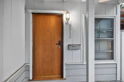 a wooden door on the side of a house at Luxury Cozy 2BR 1BA near LAX, LMU, SoFi Stadium, Beach in Los Angeles