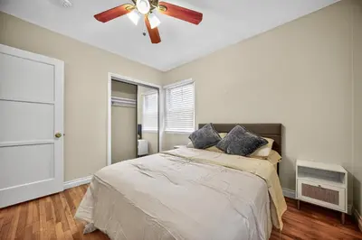 a bedroom with a bed with a ceiling fan at Luxury Cozy 2BR 1BA near LAX, LMU, SoFi Stadium, Beach in Los Angeles