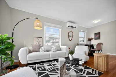 a living room with a white couch and a table at Cozy Modern 2BR 1BA near LAX, LMU, SoFi Stadium and the Beach in Los Angeles