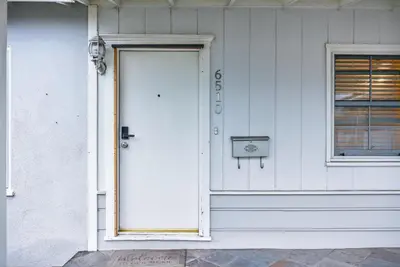a white door on the side of a house at Cozy Modern 2BR 1BA near LAX, LMU, SoFi Stadium and the Beach in Los Angeles