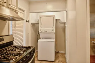 a small kitchen with a refrigerator and a stove at Stylish LAX Area 2BR 1BA by LMU, SoFi Stadium & Coastal Beaches in Los Angeles