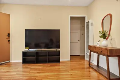 a living room with a large flat screen tv at Stylish LAX Area 2BR 1BA by LMU, SoFi Stadium & Coastal Beaches in Los Angeles