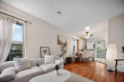 a living room with a white couch and a table at Cozy Comfort Stylish 2BR 1BA near LAX, LMU, SoFi Stadium & Beaches in Los Angeles
