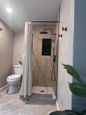 a bathroom with a shower with a toilet at Bright & Spacious 5BR Modern Vacation Home - Near Disneyland & Beaches in Orange