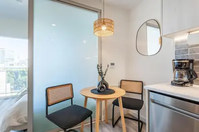 a small table and chairs in a kitchen with a window at Boutique Mini 1 BD Residence in Los Angeles