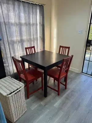 a dining room table with four chairs and a window at Long Beach vocation home in Long Beach