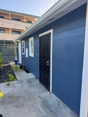 a blue building with a door in the side of it at Long Beach vocation home in Long Beach