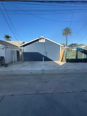 a white house with a ramp in a driveway at Long Beach vocation home in Long Beach