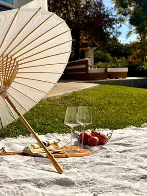 a table with two wine glasses and an umbrella at The Chapel - Luxury Historic Ojai Villa in Ojai