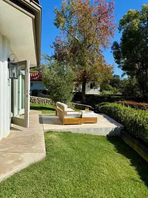 a couch sitting on a lawn next to a house at The Chapel - Luxury Historic Ojai Villa in Ojai
