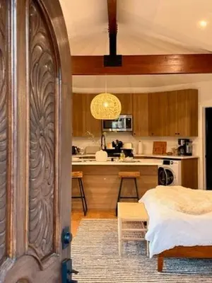 a room with a kitchen with a bed and a table at The Chapel - Luxury Historic Ojai Villa in Ojai