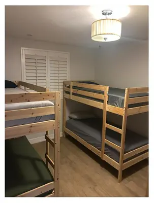 two bunk beds in a room with a lamp at Normandie Good Vibes Only in Los Angeles