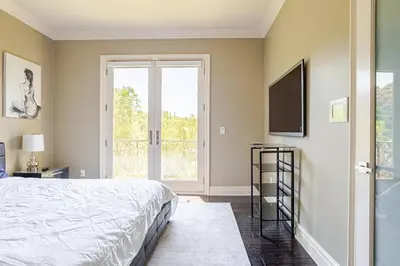 a bedroom with a bed and a flat screen tv at Mansion in the hills near Universal Studios!