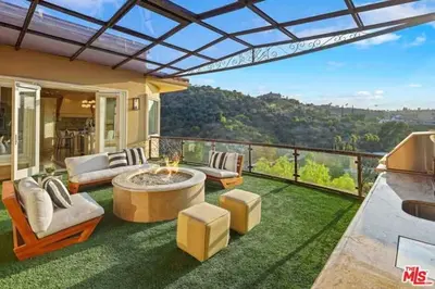 a living room with a patio with a table and chairs at Mansion in the hills near Universal Studios!