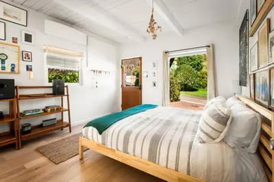 a bedroom with a large bed and a window at Laurel Canyon Hideaway Fireplace and Sauna in Los Angeles