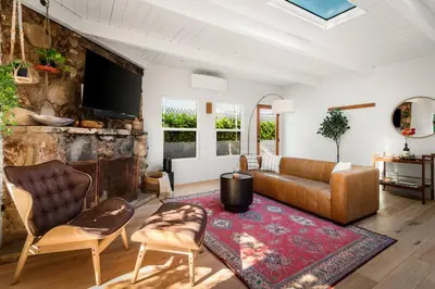 a living room with a couch and a tv at Laurel Canyon Hideaway Fireplace and Sauna in Los Angeles
