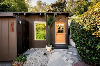 a house with a potted plant in front of a door at Laurel Canyon Hideaway Fireplace and Sauna in Los Angeles