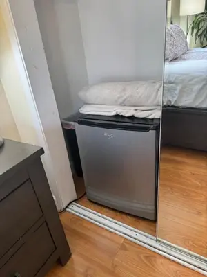 a small room with a bed and a mirror at Proper Stays at Melrose - West Hollywood Premium E suite in Los Angeles