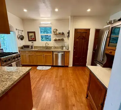 a kitchen with wooden floors and a sink and a stove at Culver Adjacent Spanish in Los Angeles