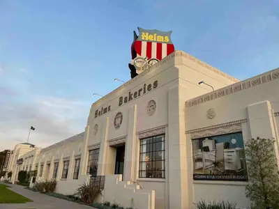 a building with an american flag on top of it at Culver Adjacent Spanish in Los Angeles