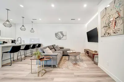 a living room with a couch and a kitchen at Modern 3BR with King Bed, Gated Pool and BBQ Oasis in West Valley Area Heliport
