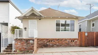 a house with a brick fence and a gate at Sunny Venice Beach Home with Open Living Walkability to Abbot Kinney Venice Drift by AvantStay in Los Angeles