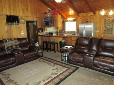 a living room with leather furniture and a kitchen at M & M Sweet Retreat in Big Bear Lake