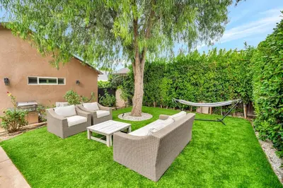 a yard with two couches and a tree at Charming 3BR with Ping-Pong and Spa!