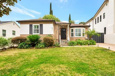 a house with a lawn in front of it at Charming 3BR with Ping-Pong and Spa!