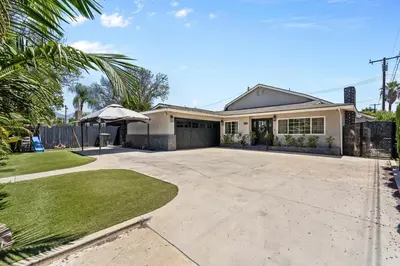 a house with a large driveway in front of it at Wonderful Home Near Claremont! With Amazing Backyard! in Pomona